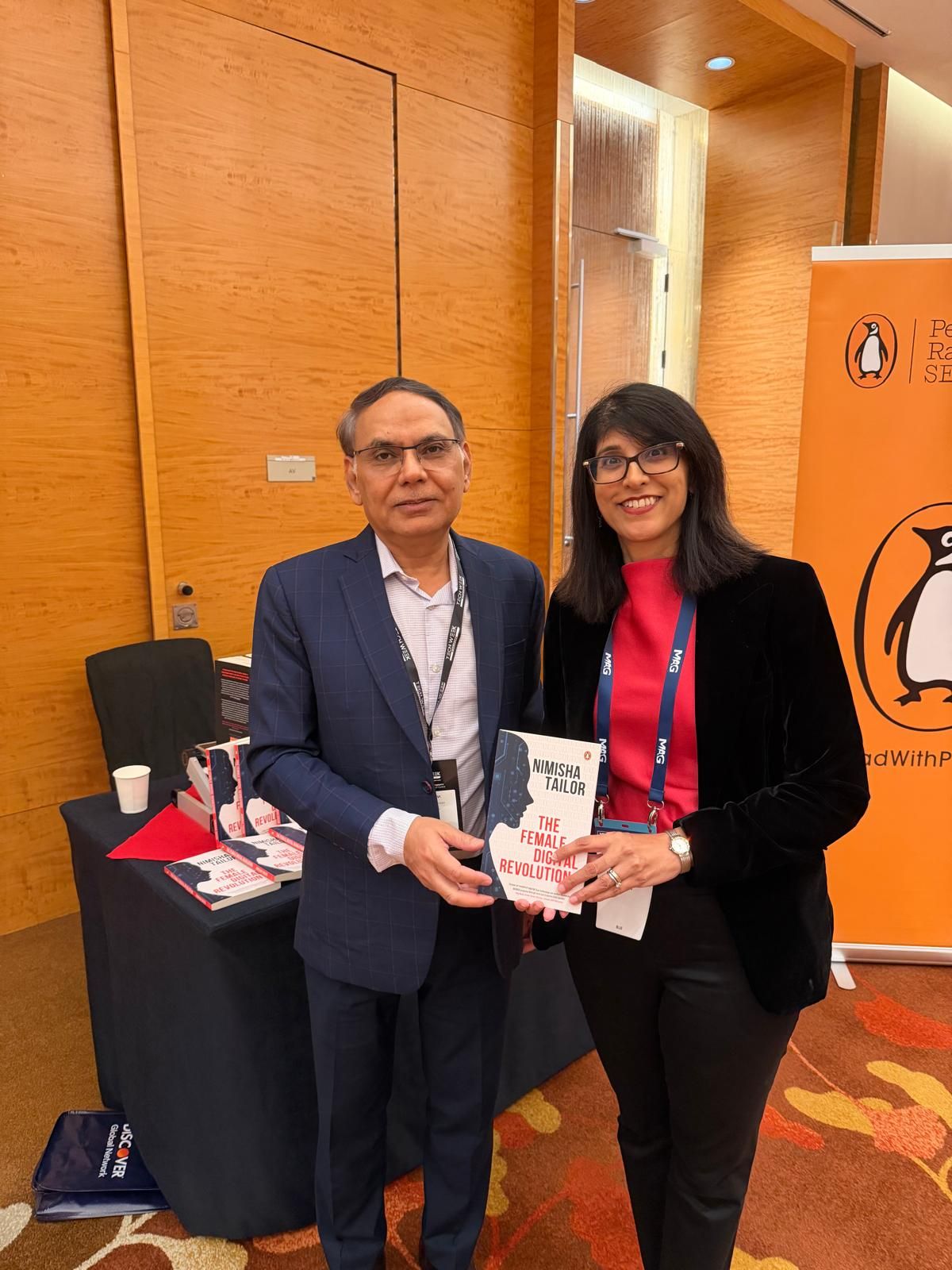 Dr Aftab Rizvi being presented with a book gift during Tech Week Singapore 2025.